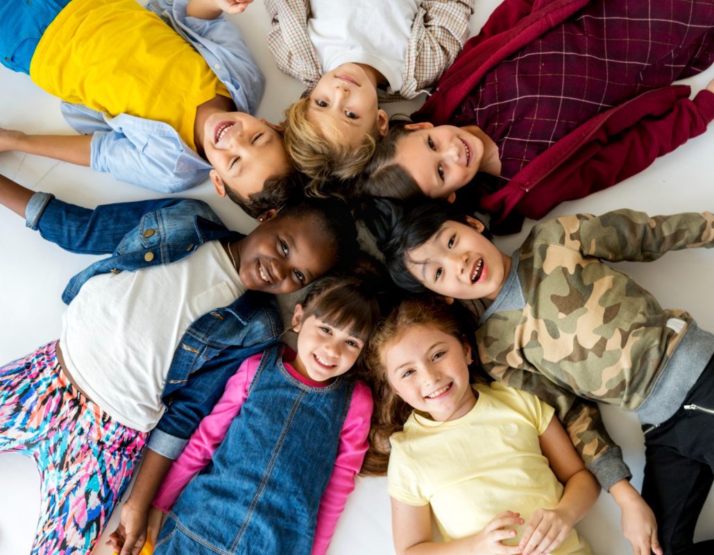 group of primary schoolers lying on the ground