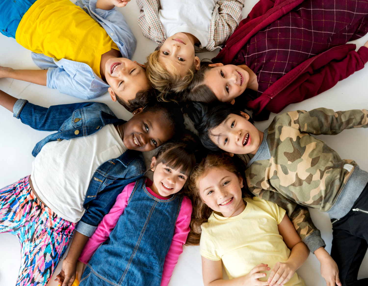 group of primary schoolers lying on the ground